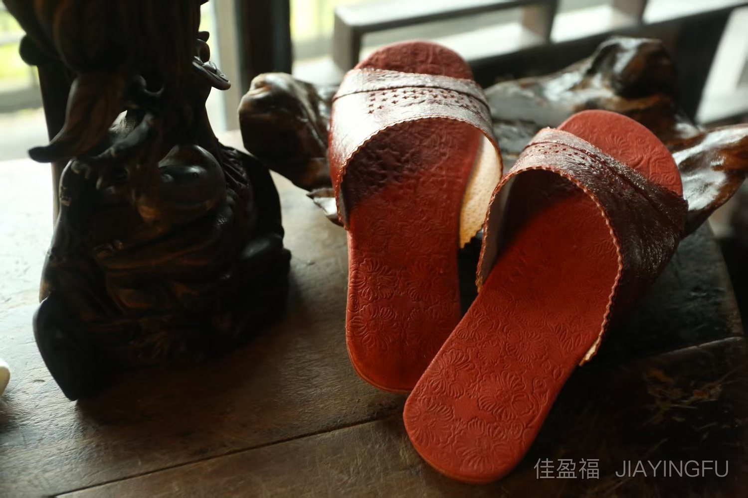 Red leather slippers on table